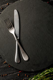 Knife and fork on black background