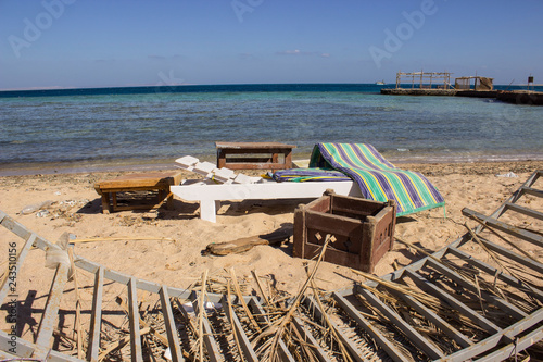old chairs and mattress on the beach