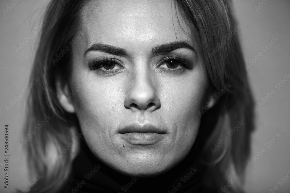 Dramatic black and white portrait of a beautiful woman on a dark background Dramatic black and white portrait of a beautiful woman on a dark background