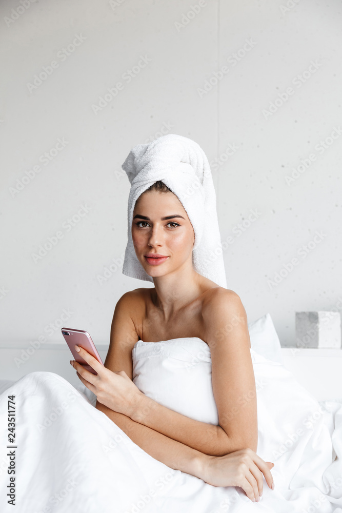 Beautiful young woman wrapped in bath towel Beautiful young woman wrapped in bath towel