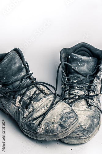 old, dirty boots isolated on white background