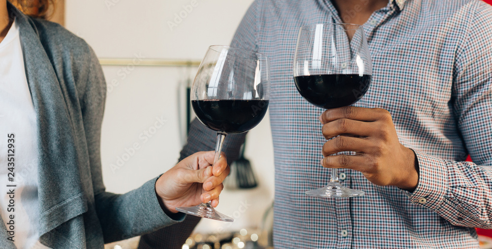 Happy couple celebrating and cheering with glasses of wine Happy couple celebrating and cheering with glasses of wine