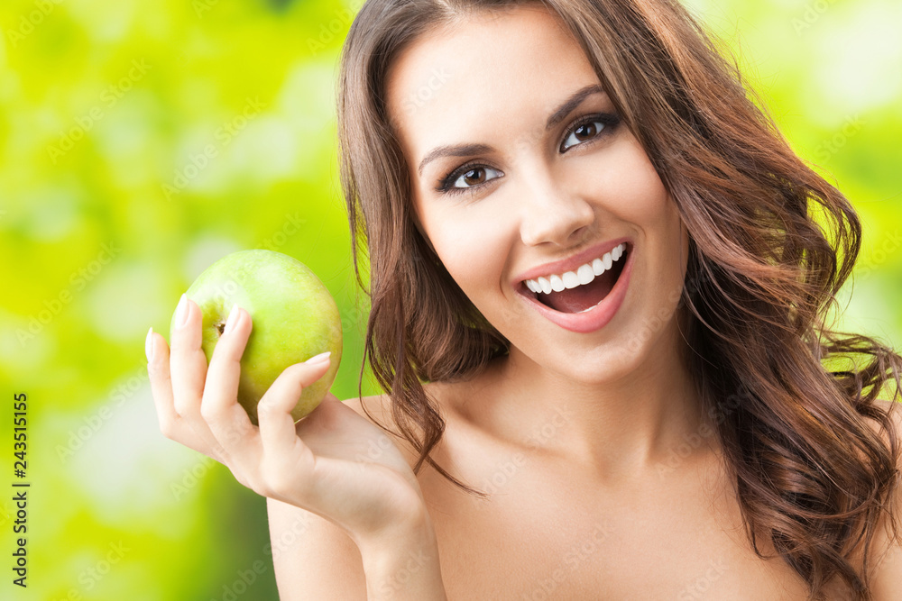 Young happy smiling woman with apple, outdoors Young happy smiling woman with apple, outdoors