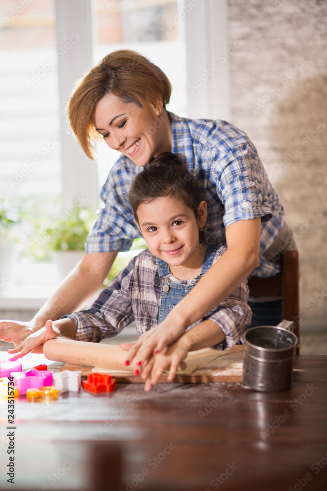 Mom and daughter prepare cookies in the kitchen