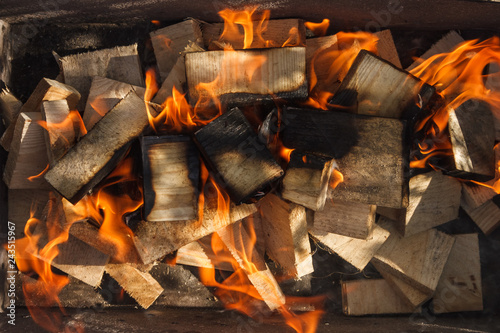 The wood burns in a homemade barbecue