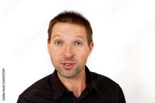 Portrait of a puzzled young man on a white background