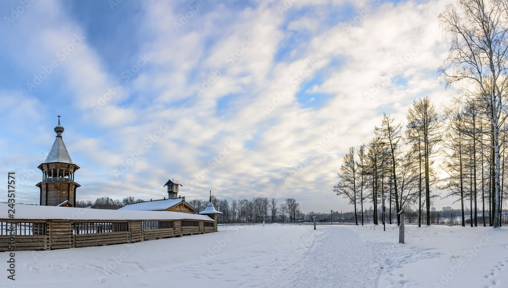 Winter day in the forest Park. Wooden Pokrovsky Cathedral, a monument of wooden architecture.