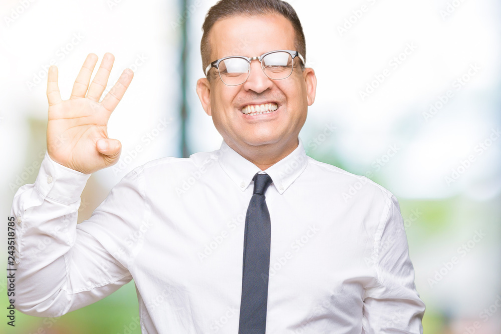 Middle age bussines arab man wearing glasses over isolated background showing and pointing up with fingers number four while smiling confident and happy. Middle age bussines arab man wearing glasses over isolated background showing and pointing up with fingers number four while smiling confident and happy.
