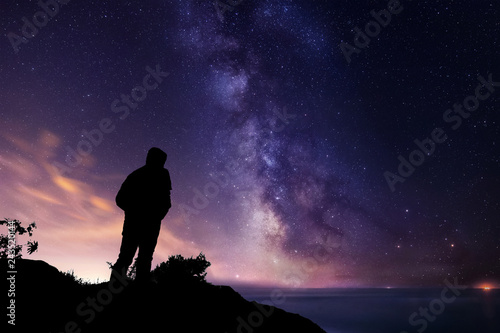 Silhouette of a man watching the Milky way and the Stars photo