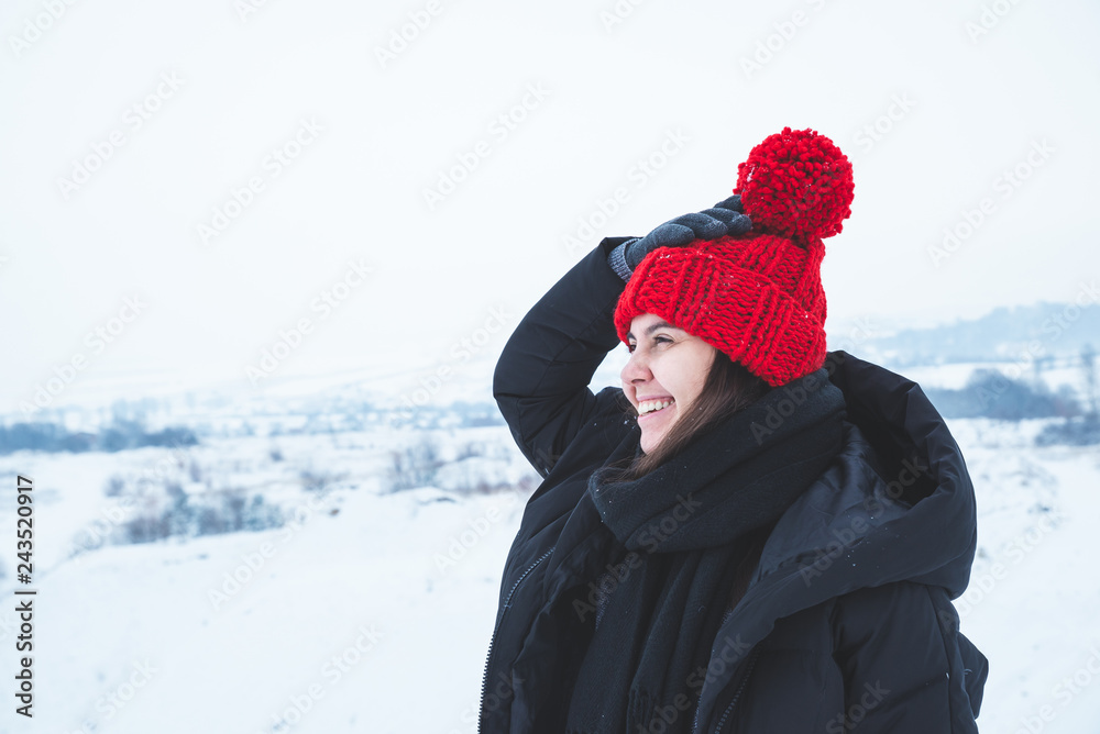 young adult woman in winter clothes with red bright hat outdoors young adult woman in winter clothes with red bright hat outdoors