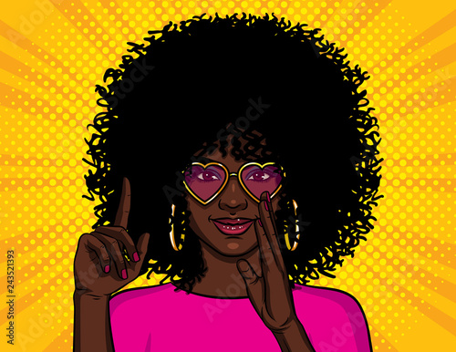 Color vector illustration in pop art style. African American girl shows thumb up. A girl with pink glasses wants to tell a secret. Character design for advertising discounts, sales and offers