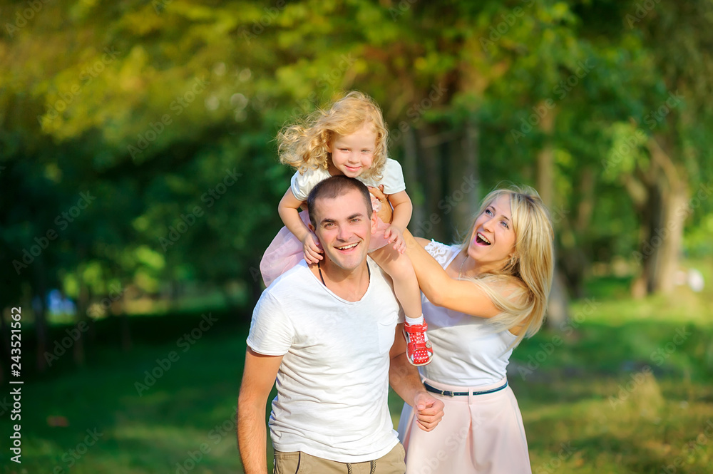 happy family in the evening park, walking and having fun