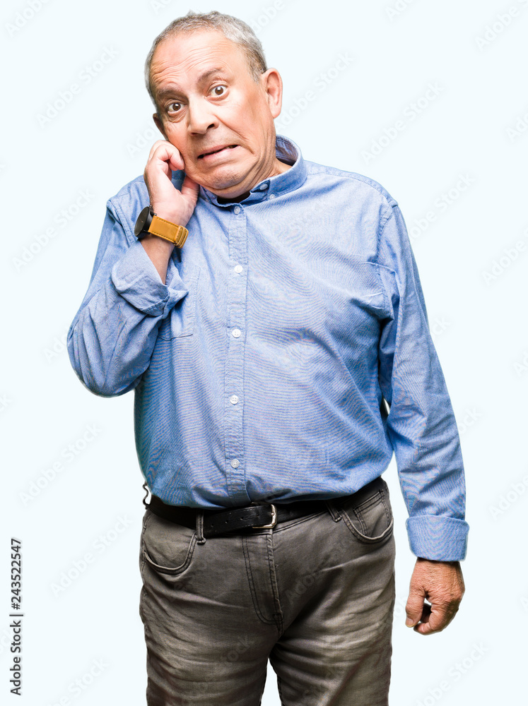 Handsome senior businesss man wearing elegant shirt looking stressed and nervous with hands on mouth biting nails. Anxiety problem.