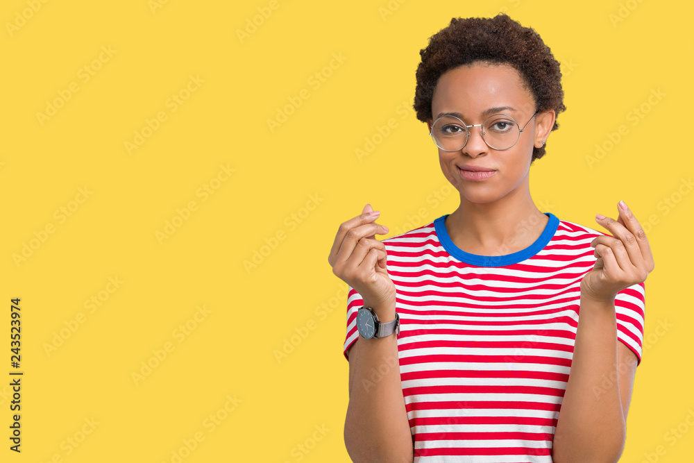Beautiful young african american woman wearing glasses over isolated background Doing money gesture with hand, asking for salary payment, millionaire business Beautiful young african american woman wearing glasses over isolated background Doing money gesture with hand, asking for salary payment, millionaire business