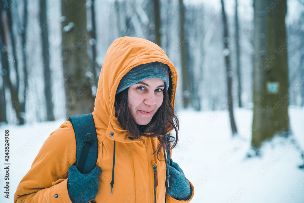 portrait of young pretty woman in coat with hood in snowed forest portrait of young pretty woman in coat with hood in snowed forest
