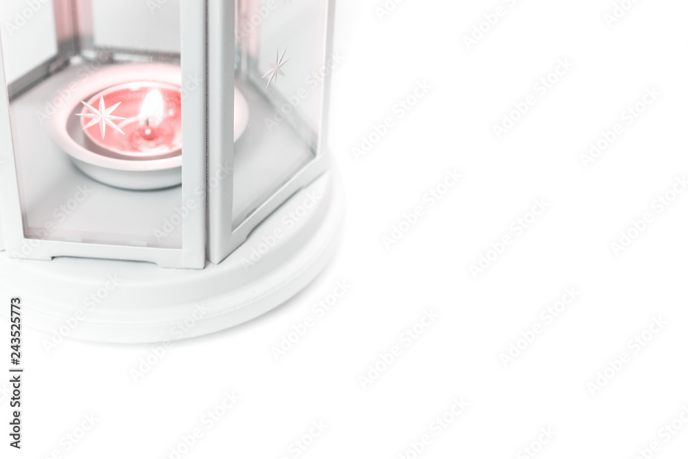 Holiday lantern with burning candle in it on white table with copy space Holiday lantern with burning candle in it on white table with copy space