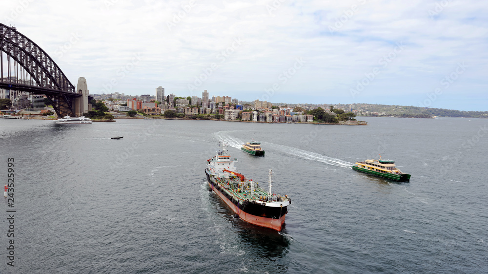 Passenger ferries and fuel ship heading across Sydney Harbor to Circular Quay in Sydney, Nes South Wales, Australia 