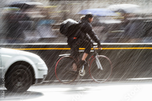 cyclist on a city street at heavy rain