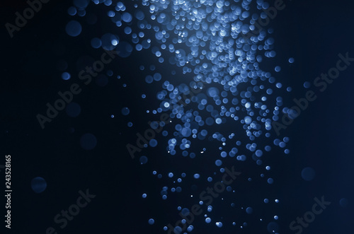 abstract blue bokeh bright glitter sparkle glowing background. for template web advertising design brand, backdrop, party, new year christmas celebration etc.