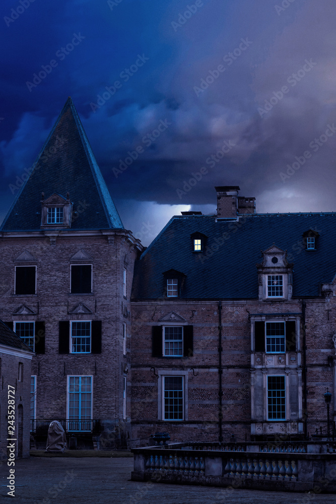 Old castle with illuminated window at dusk. Old castle with illuminated window at dusk.