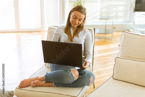 Woman using a laptop while ...
