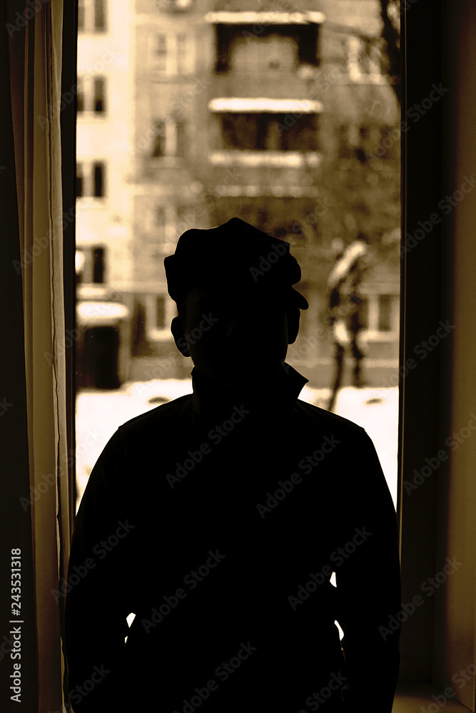 silhouette of a man in a window silhouette of a man in a window