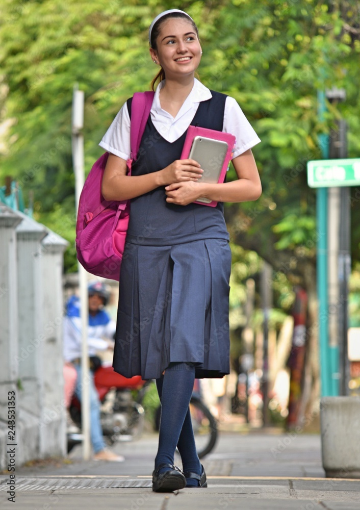 High School Girl Walking On Sidewalk High School Girl Walking On Sidewalk