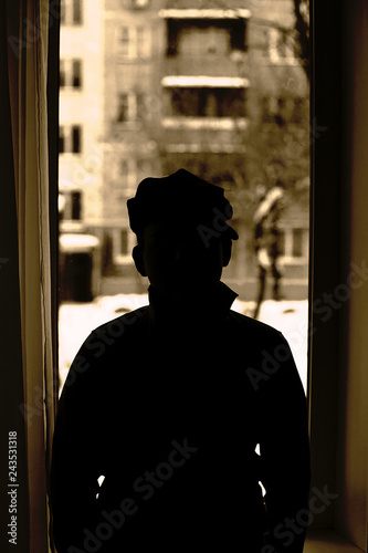 silhouette of a man in a window