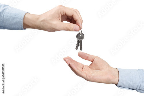 Hands of two people, giving and taking keys, isolated on white background