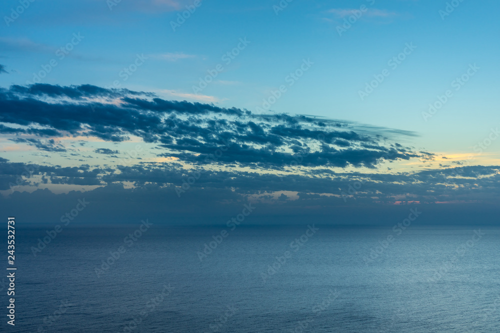 Beautiful endless ocean water horizon and sunset sky afterglow