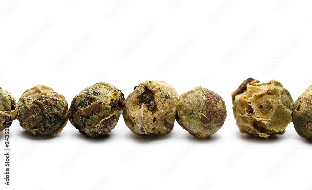 Dry green pepper pile, macro peppercorn isolated on white Dry green pepper pile, macro peppercorn isolated on white