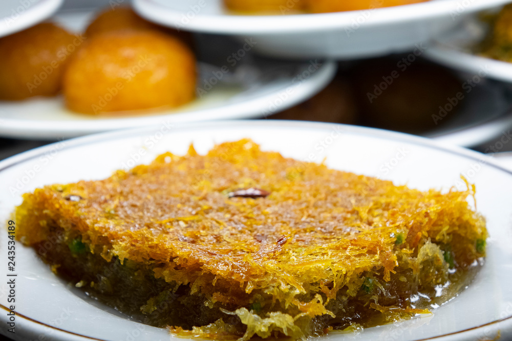 Turkish dessert with walnut. Close up turkish shredded wheat dessert with pistachio filling Turkish dessert with walnut. Close up turkish shredded wheat dessert with pistachio filling