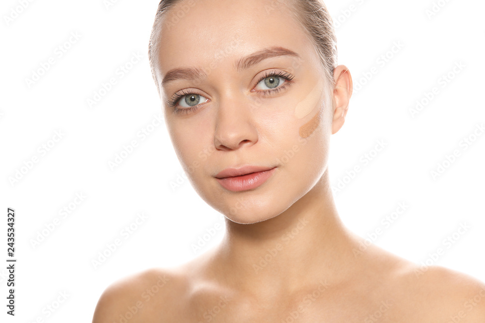 Young woman with different shades of skin foundation on her face against white background Young woman with different shades of skin foundation on her face against white background