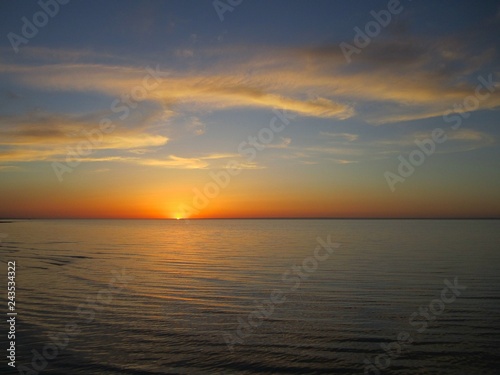 Waves on the lake and sunset © Tatiana
