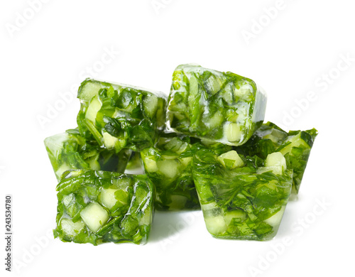 Ice cubes with cucumber slices and herbs on white background