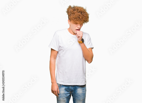 Young handsome man with afro hair wearing casual white t-shirt feeling unwell and coughing as symptom for cold or bronchitis. Healthcare concept.