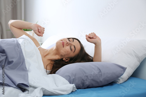 Photos Young woman awakening at home in morning. Bedtime