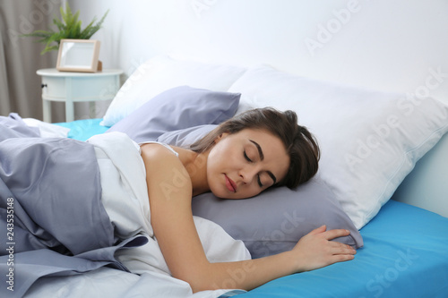 Young woman sleeping on soft pillow at home. Bedtime
