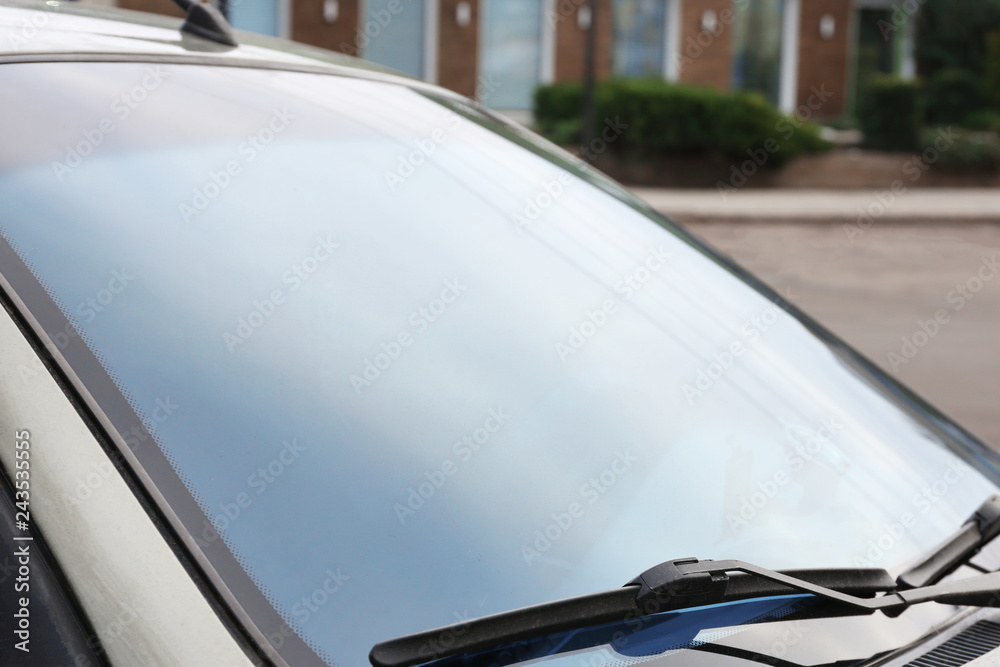 Modern car with tinting foil on window, closeup Modern car with tinting foil on window, closeup