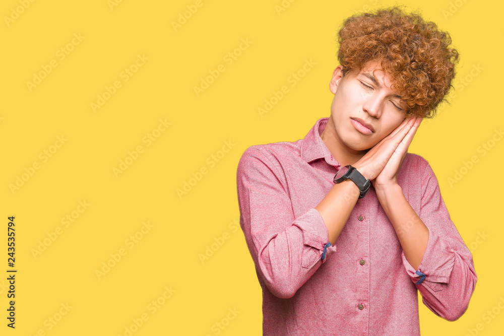 Young handsome business man with afro hair sleeping tired dreaming and posing with hands together while smiling with closed eyes. Young handsome business man with afro hair sleeping tired dreaming and posing with hands together while smiling with closed eyes.