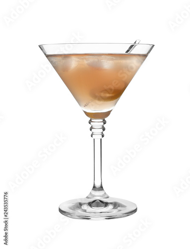 Glass of martini cocktail with ice cubes and lemon zest on white background