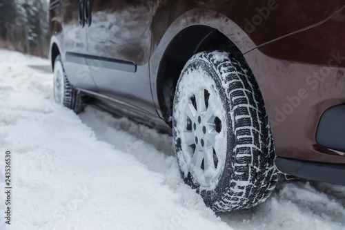 Closeup view of car in snow near road. Space for text