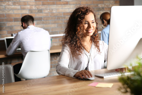 African-American technical support operator with headset at workplace photo