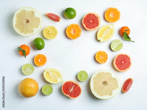 Different citrus fruits on white background, flat lay. Space for text