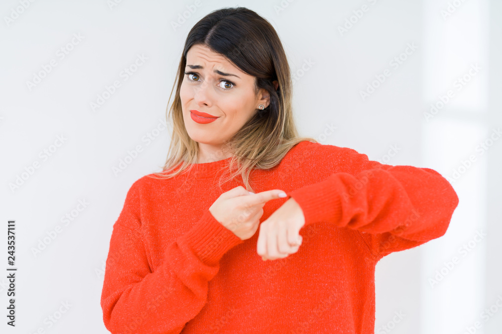 Young woman wearing casual red sweater over isolated background In hurry pointing to watch time, impatience, upset and angry for deadline delay Young woman wearing casual red sweater over isolated background In hurry pointing to watch time, impatience, upset and angry for deadline delay