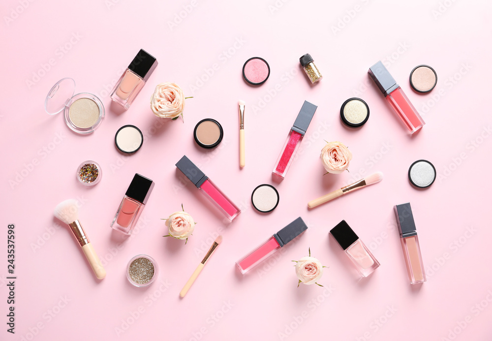 Beautiful composition with lipsticks and flowers on color background, flat lay Beautiful composition with lipsticks and flowers on color background, flat lay
