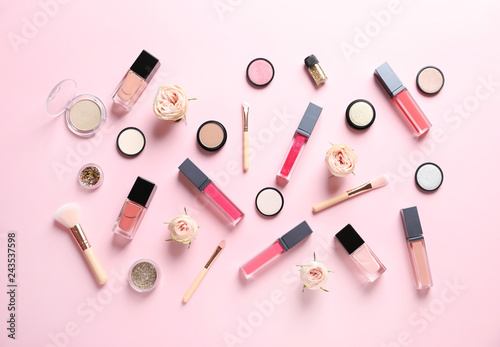 Beautiful composition with lipsticks and flowers on color background, flat lay