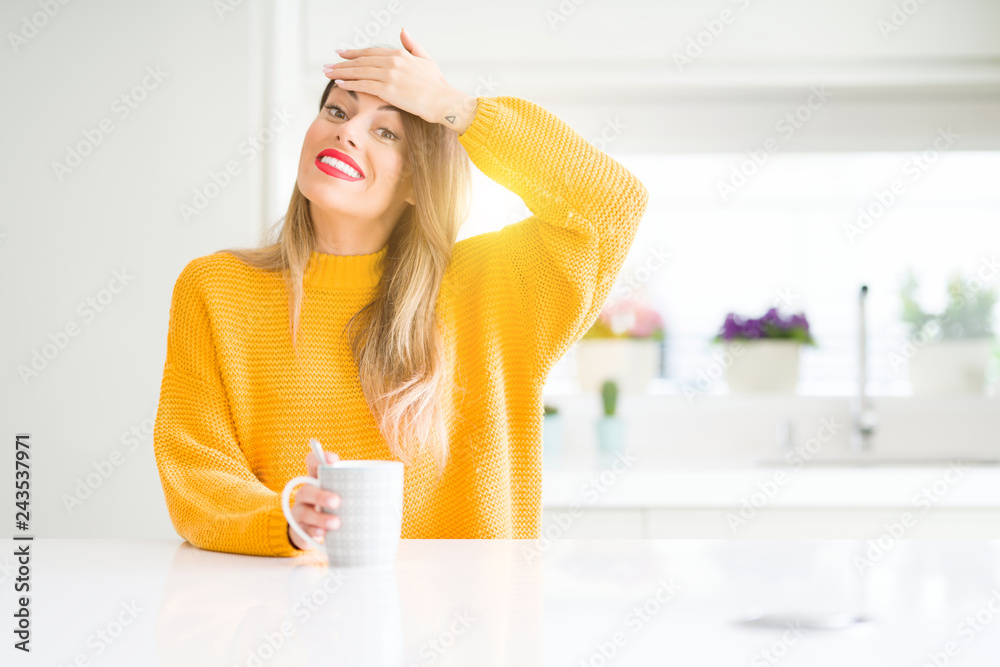 Young beautiful woman drinking a cup of coffee at home stressed with hand on head, shocked with shame and surprise face, angry and frustrated. Fear and upset for mistake. Young beautiful woman drinking a cup of coffee at home stressed with hand on head, shocked with shame and surprise face, angry and frustrated. Fear and upset for mistake.