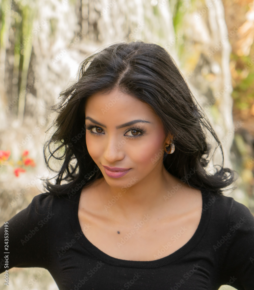 Beautiful young woman with long dark hair and exotic facial features. Beautiful young woman with long dark hair and exotic facial features.