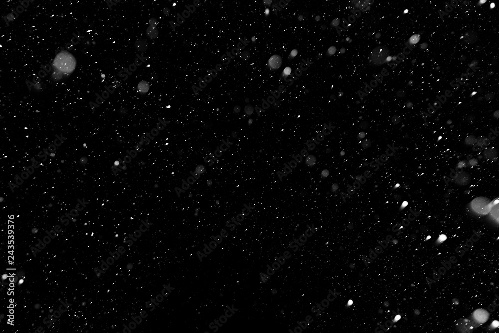 Bokeh white snow on a black night background Bokeh white snow on a black night background